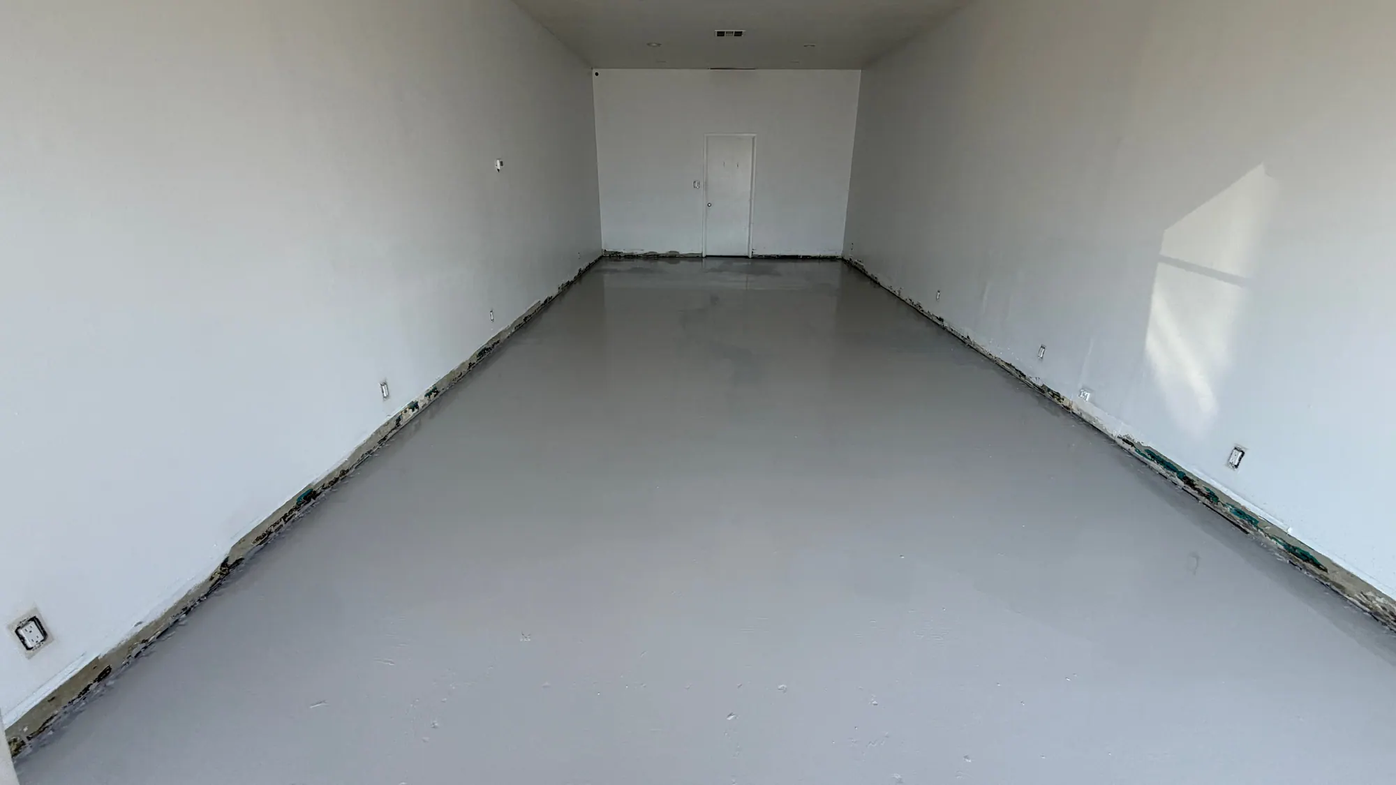 Empty retail unit after turnover, with a new seamless epoxy floor