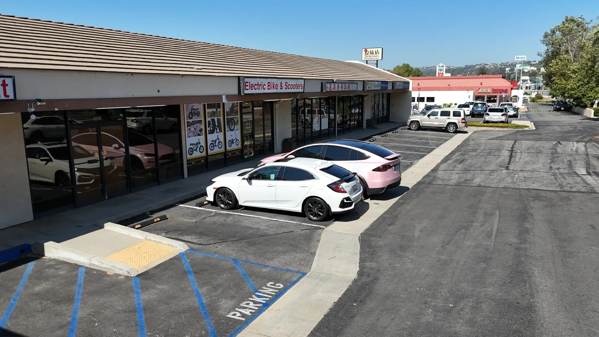 Retail center walkway, storefronts and freshly striped accessible stalls