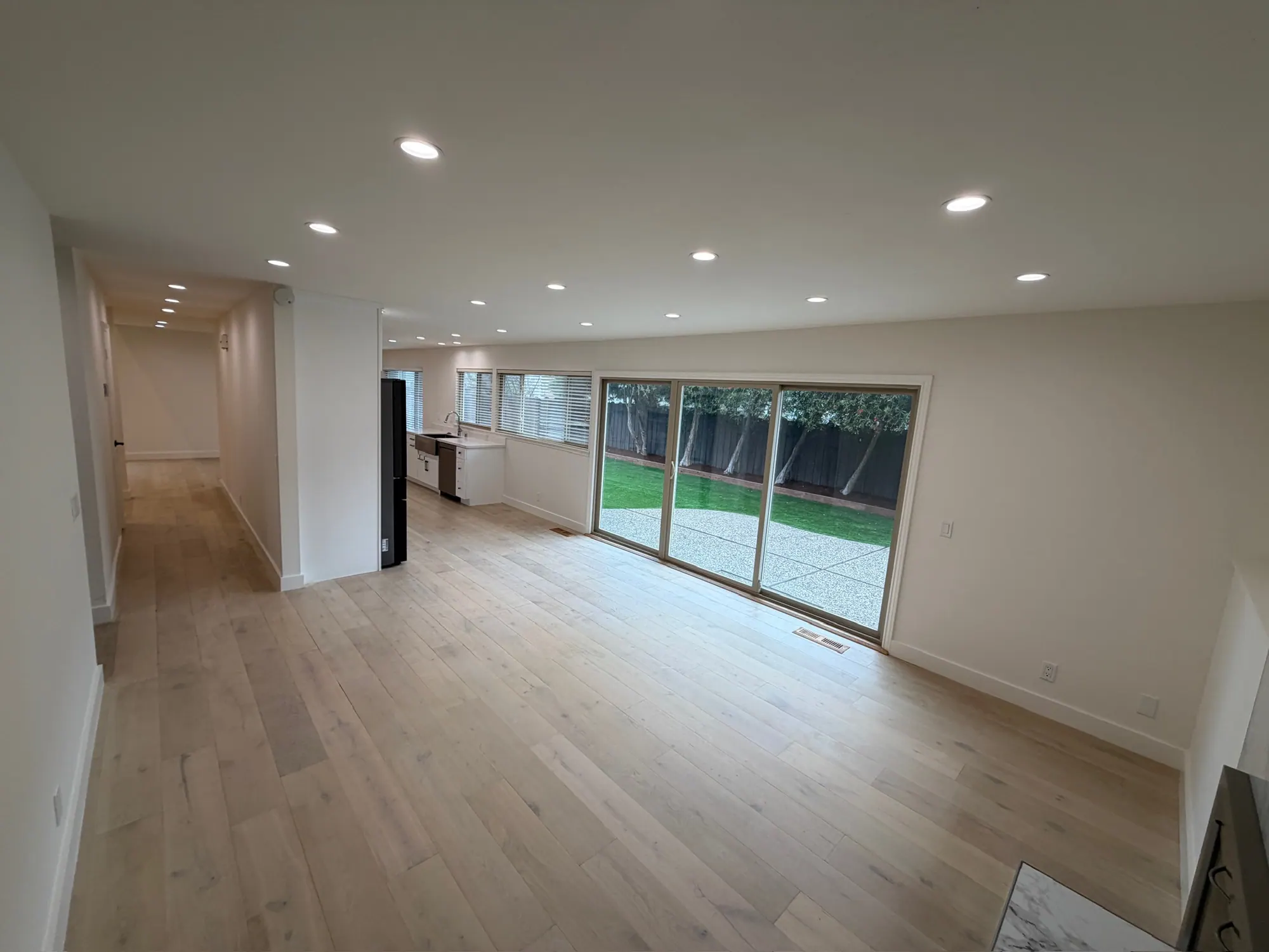 Open living space with sliding doors to the new backyard