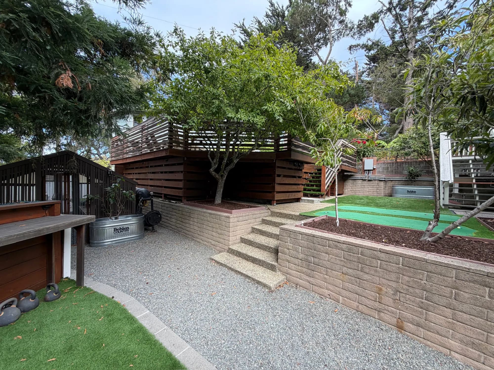 Gravel terrace, block retaining walls and steps up to the deck