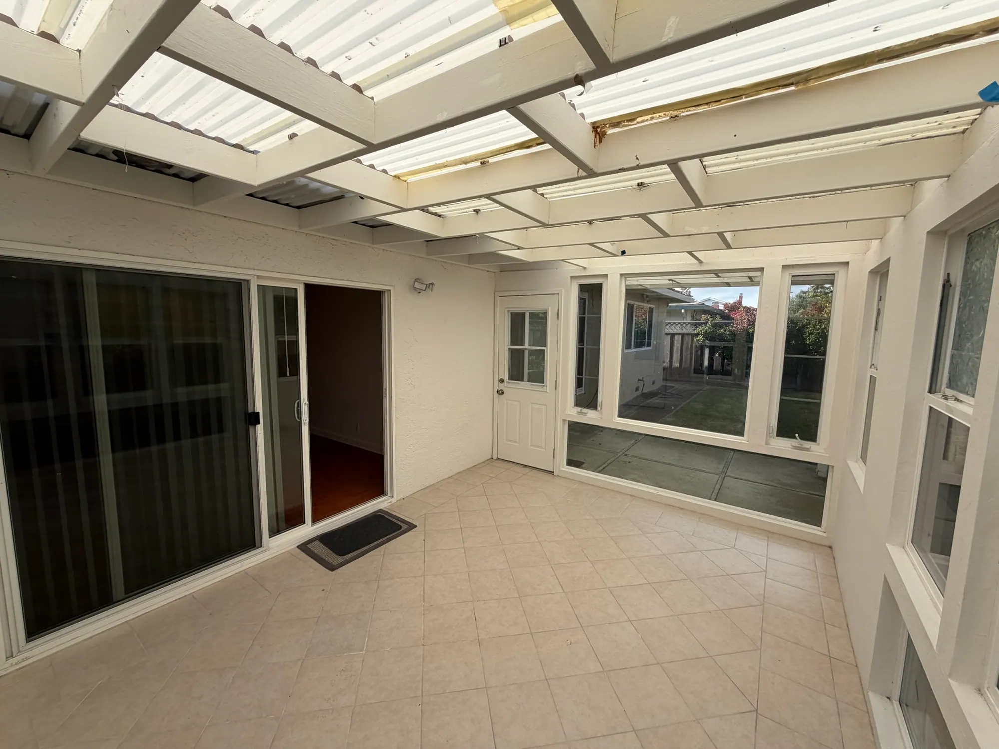 Sunroom with its old roof panels removed, before the replacement