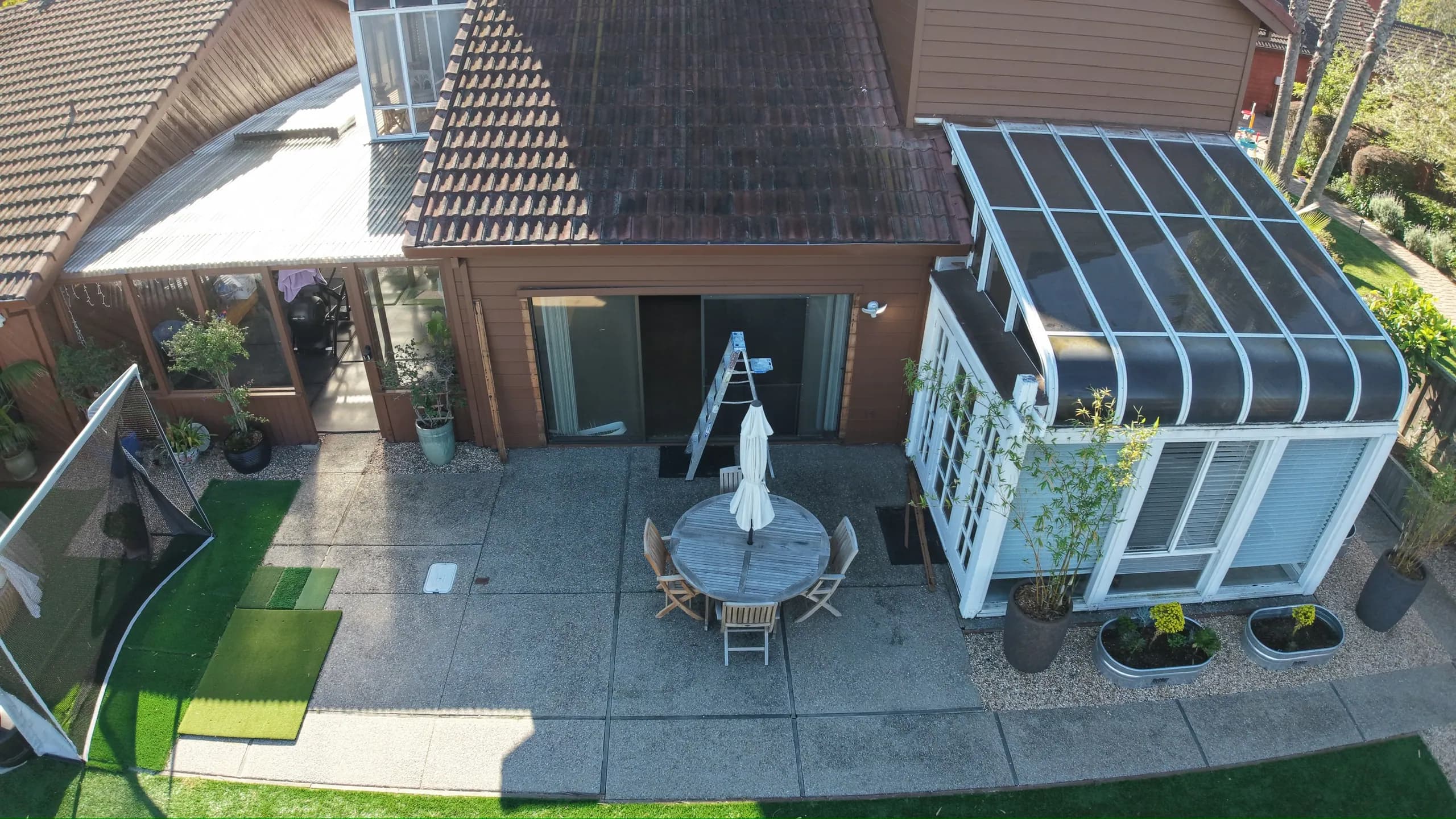 Aerial of the courtyard patio between the house and the sunroom