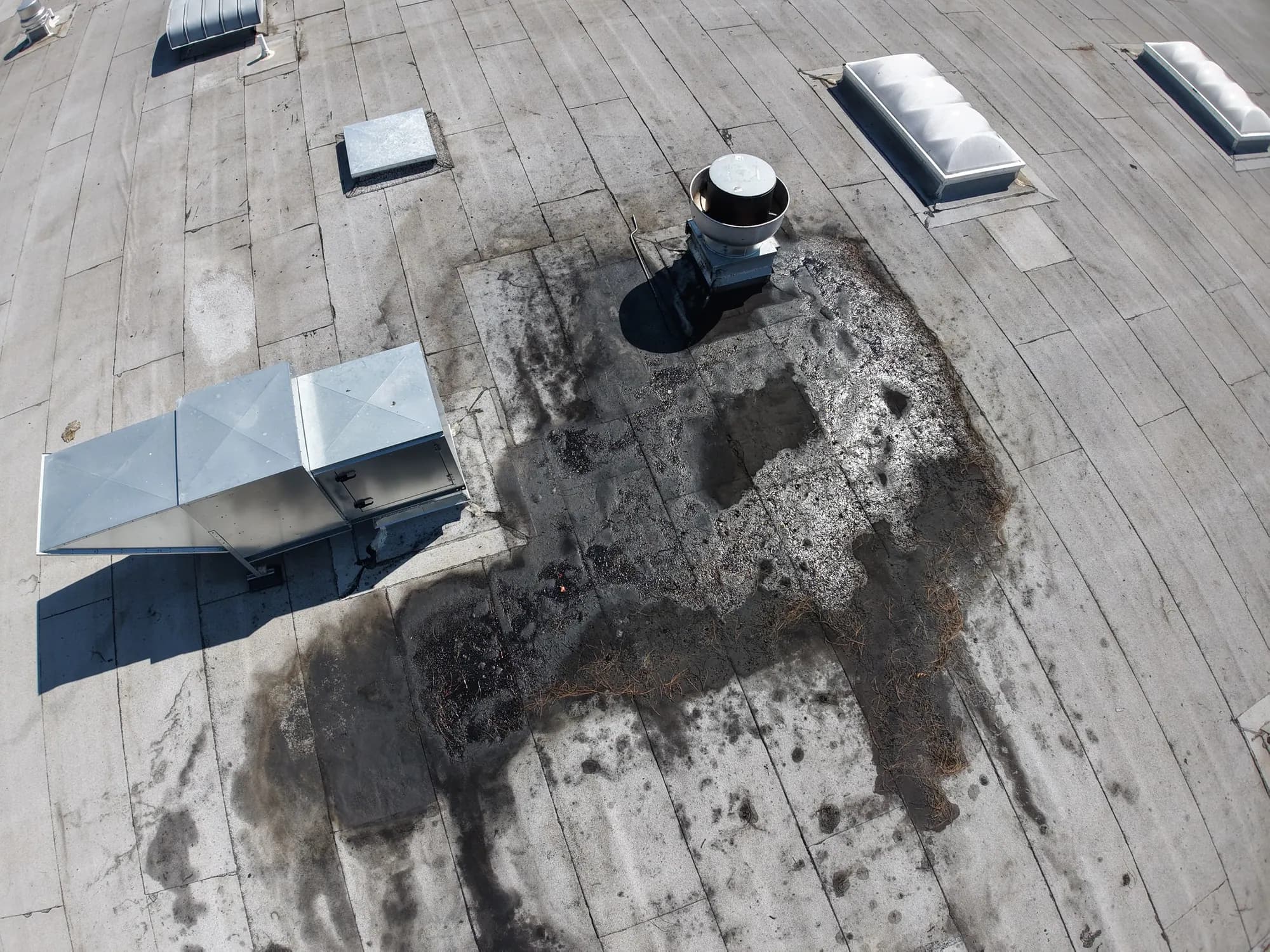 Drone survey of a flat commercial roof showing a patched area around a vent